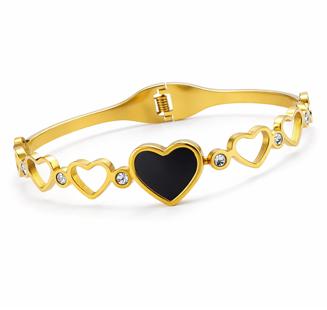 Gold bracelet with heart designs on a white background