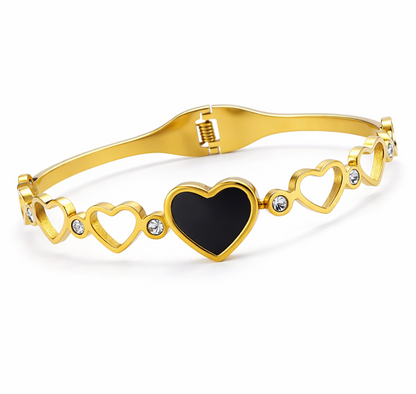Gold bracelet with heart designs on a white background