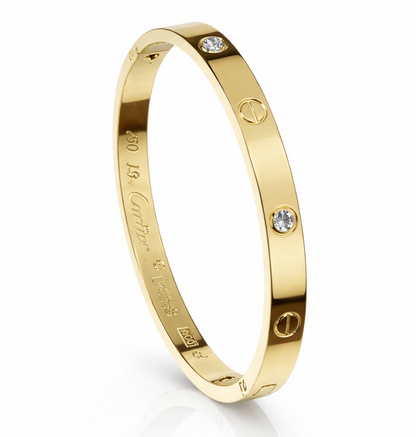 Gold bracelet with diamond accents on a white background