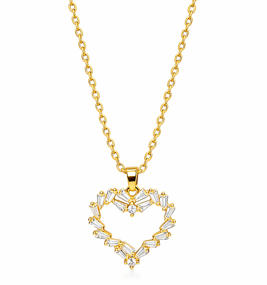 Gold necklace with a heart-shaped pendant on a white background