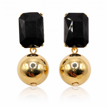 Pair of earrings with black gemstones and gold balls on a white background
