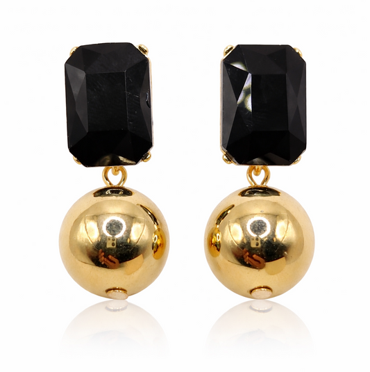 Pair of earrings with black gemstones and gold balls on a white background